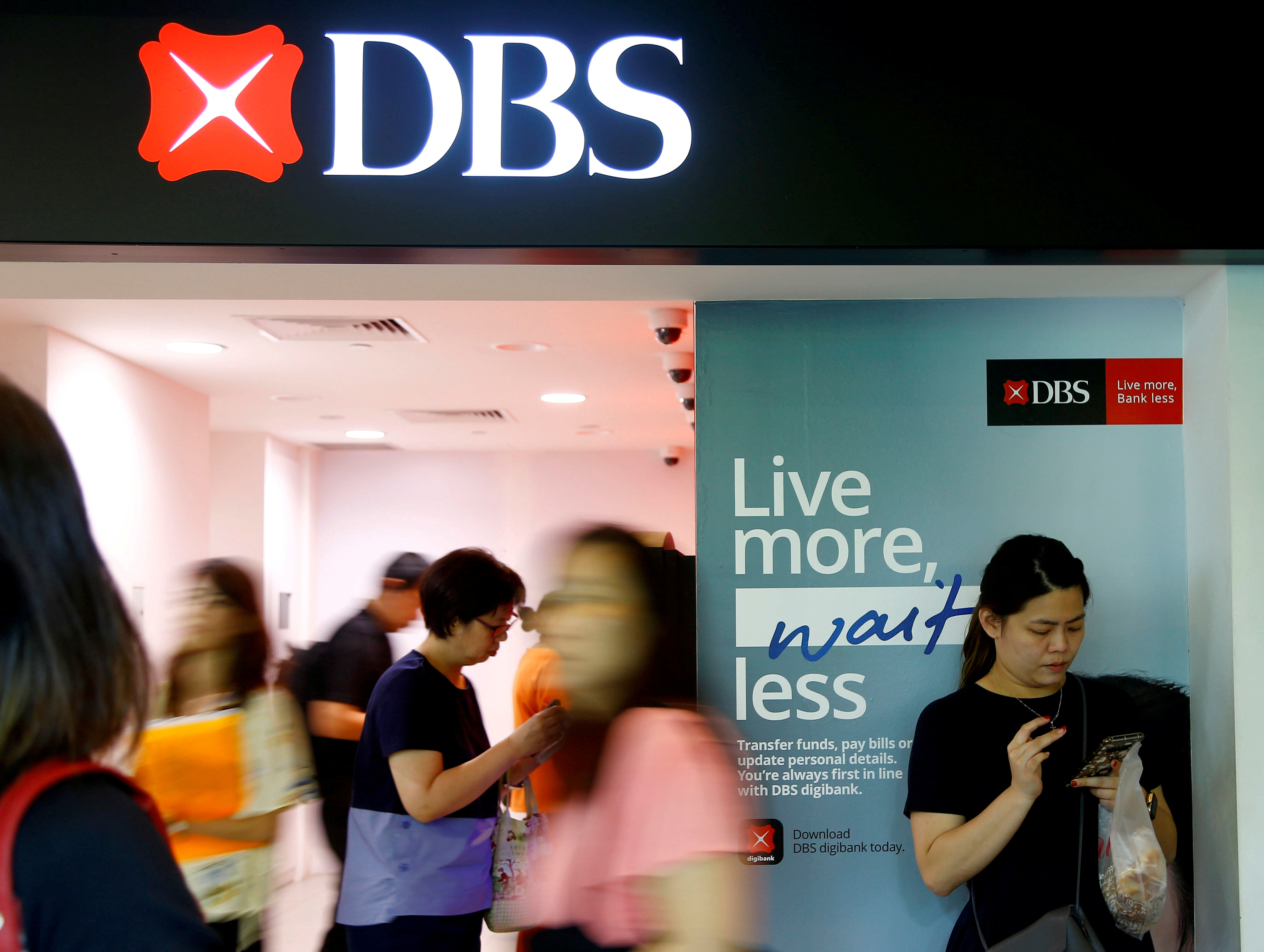 People walk past a DBS Bank. Credit: Reuters Photo
