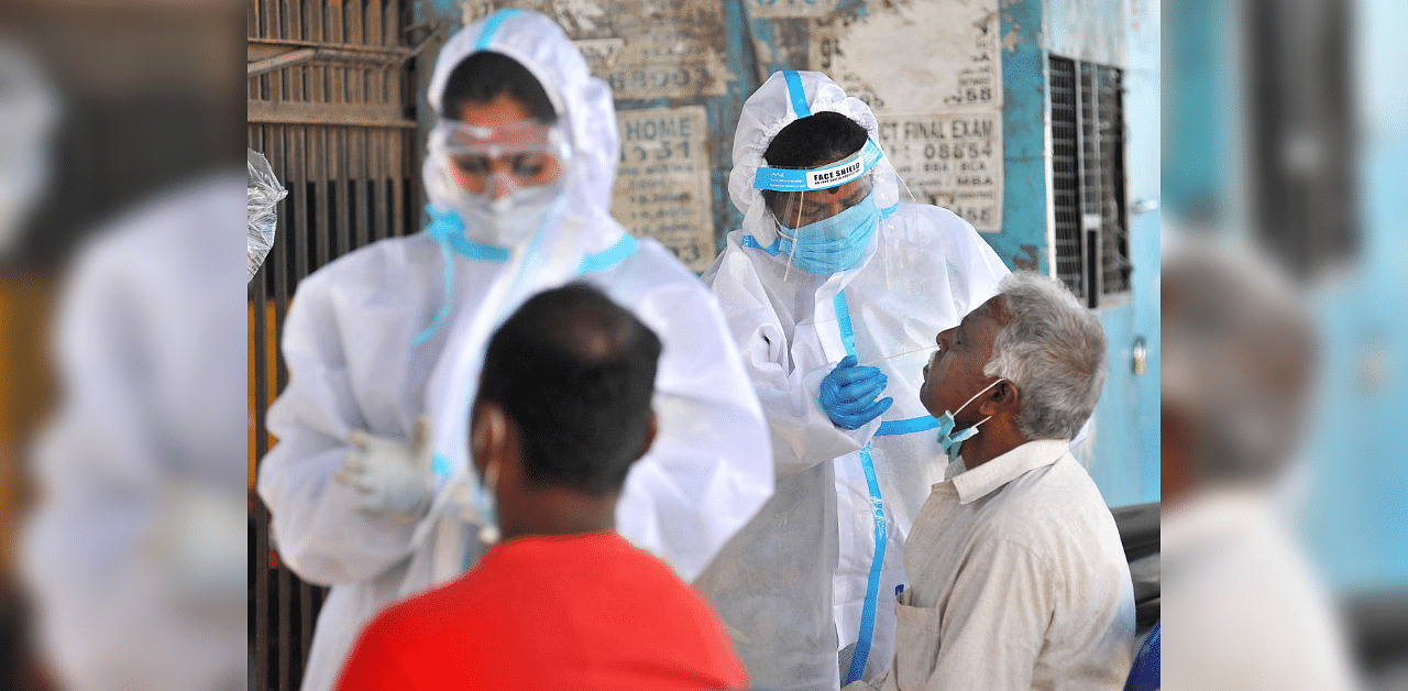 BBMP medical staff collect Covid-19 test samples from people near KR Market in Bengaluru. Credit: DH Photo