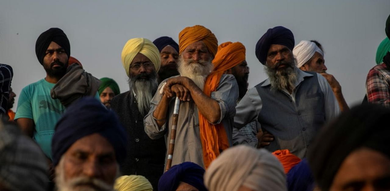 Farmers listen to a speaker as they attend a protest against the newly passed farm bills at Singhu border near Delhi, India, December 3, 2020. Credit: Reuters Photo