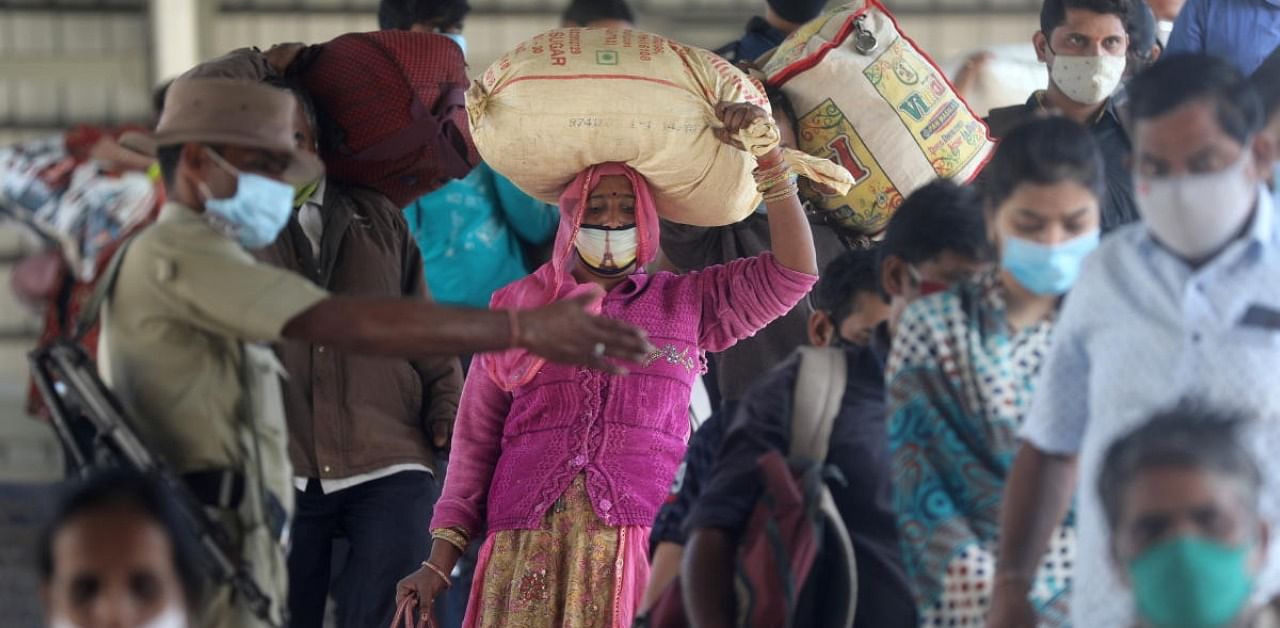 A policeman directs crowd at a railway station amidst the spread of the coronavirus disease (Covid-19) in Mumbai, India, December 4, 2020. Credit: Reuters Photo