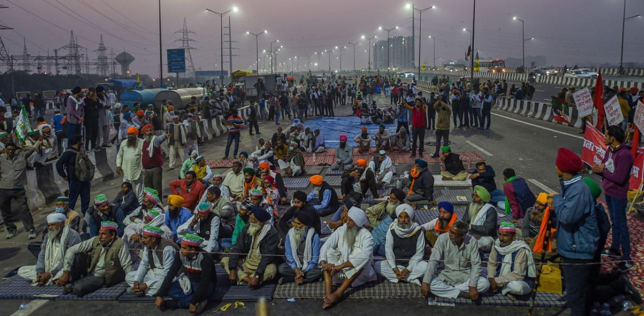 Farmers during their ongoing agitation against the Center's new farm laws, at Delhi-Noida border near Ghazipur, in New Delhi. Credit: PTI.