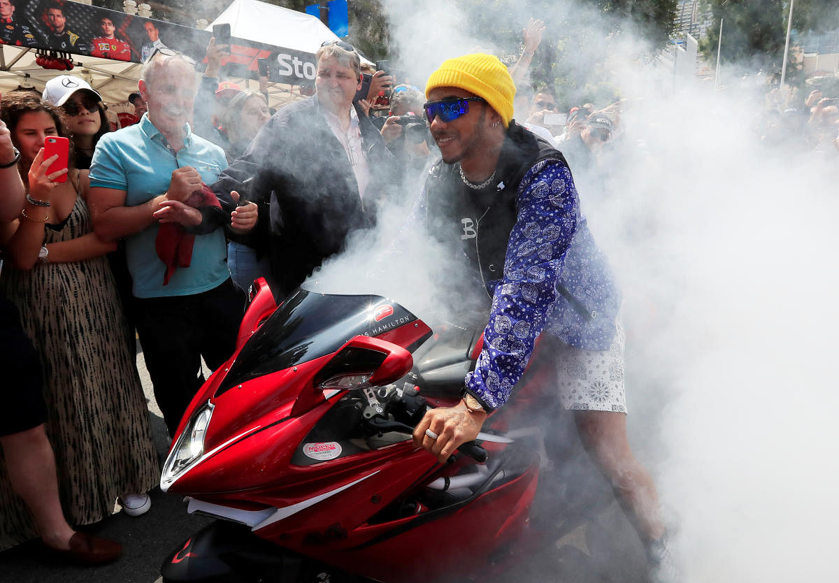 Mercedes' Lewis Hamilton on a motorbike as he leaves the fan zone on Friday. Reuters