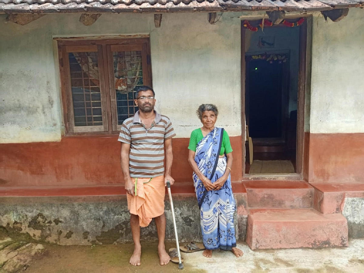 Kalana Lakshmana and his mother Devakki in front of their house in Korangala village.