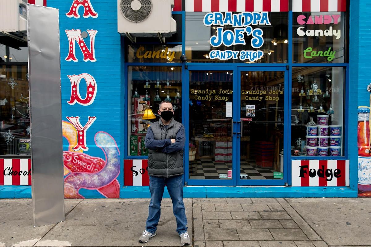 Christopher Beers, owner of Grandpa Joe's Candy Shop, stands near a monolith outside his store in Pittsburgh, Pennsylvania, US. Credit: Reuters photo. 