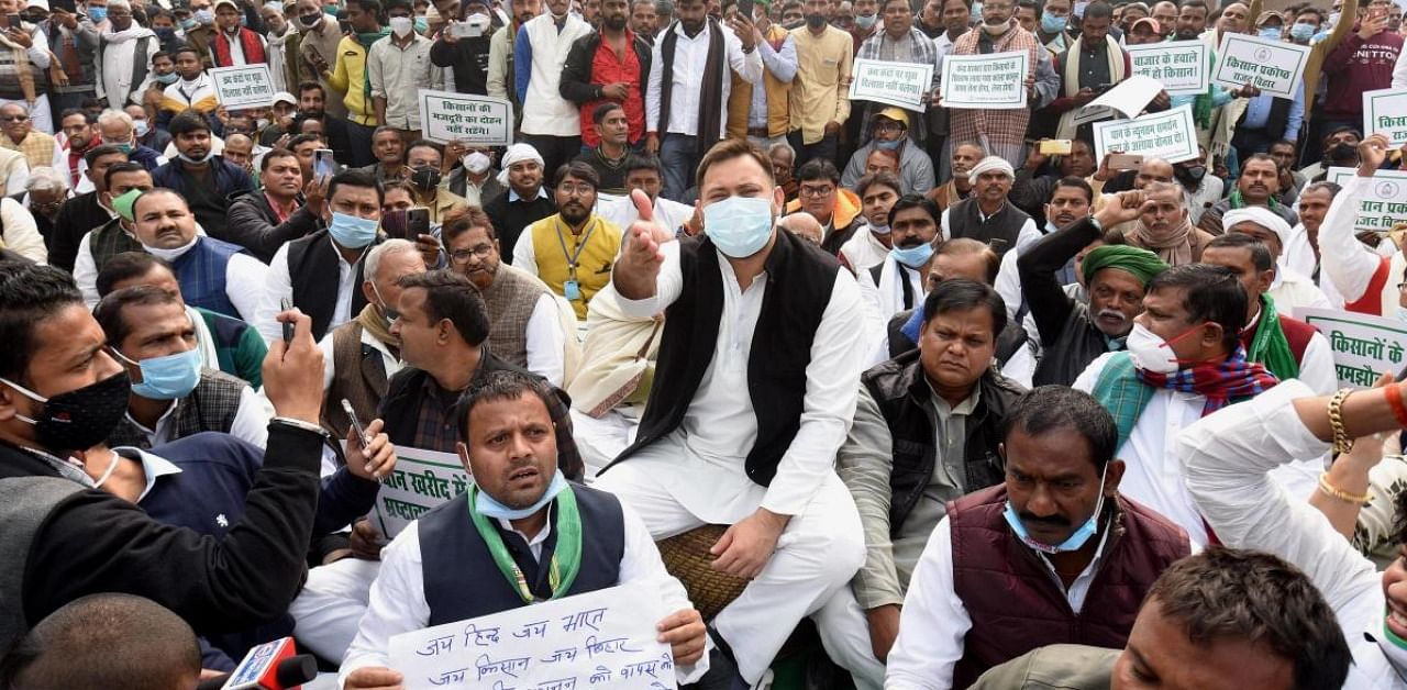 Rashtriya Janata Dal (RJD) leader Tejashwi Prasad Yadav with party leaders stages a demonstration in solidarity with farmers protesting at Delhi borders over Centre's farm reform laws, at Gandhi Maidan in Patna. Credit: PTI.
