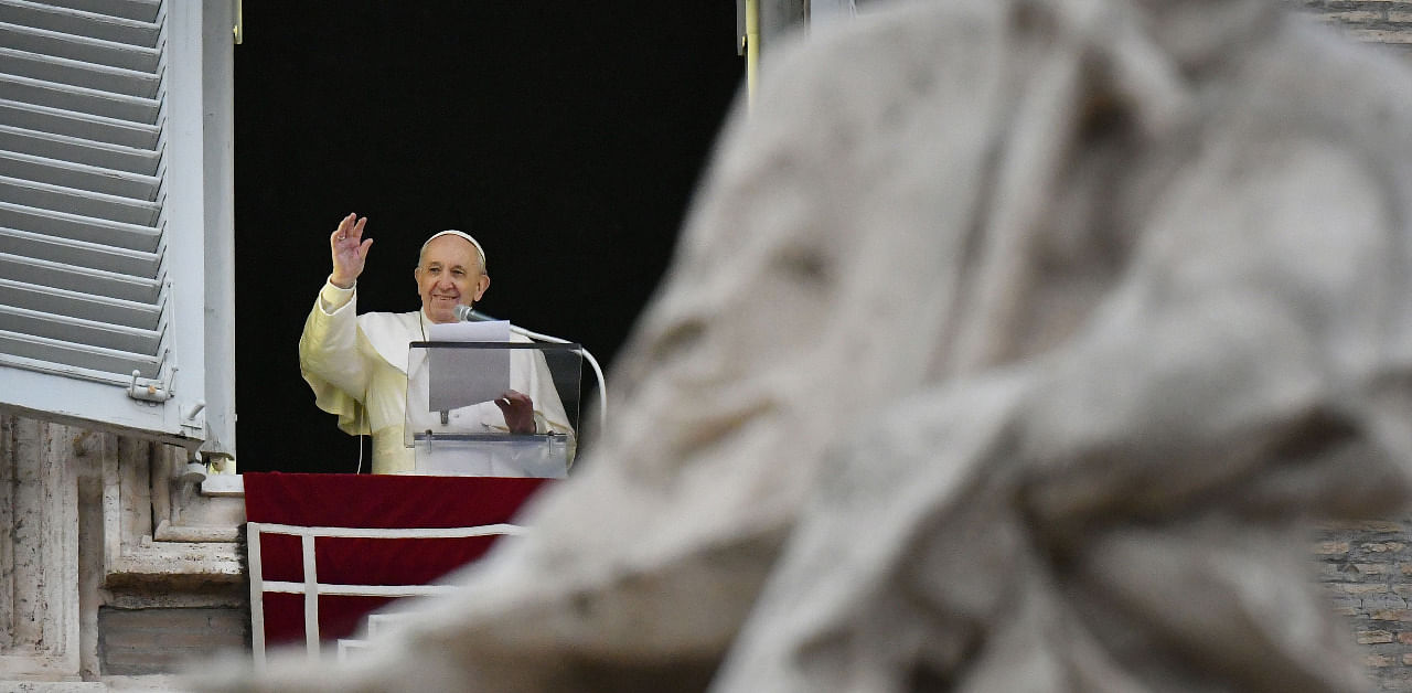 Pope Francis addresses the crowd from the window of the apostolic palace overlooking St. Peter's square during his Angelus prayer. Credit: AFP Photo