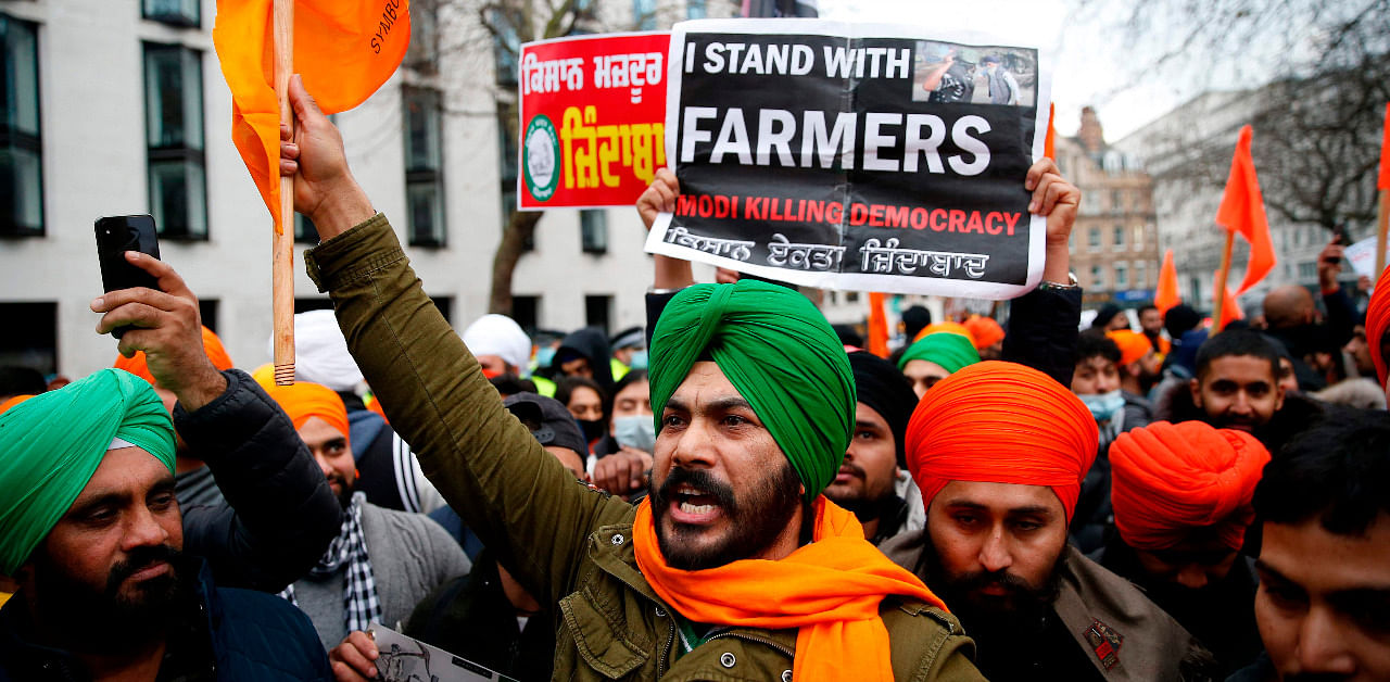 Protesters hold up placards as the gather outside the Indian High Commission in central London. Credit: AFP Photo