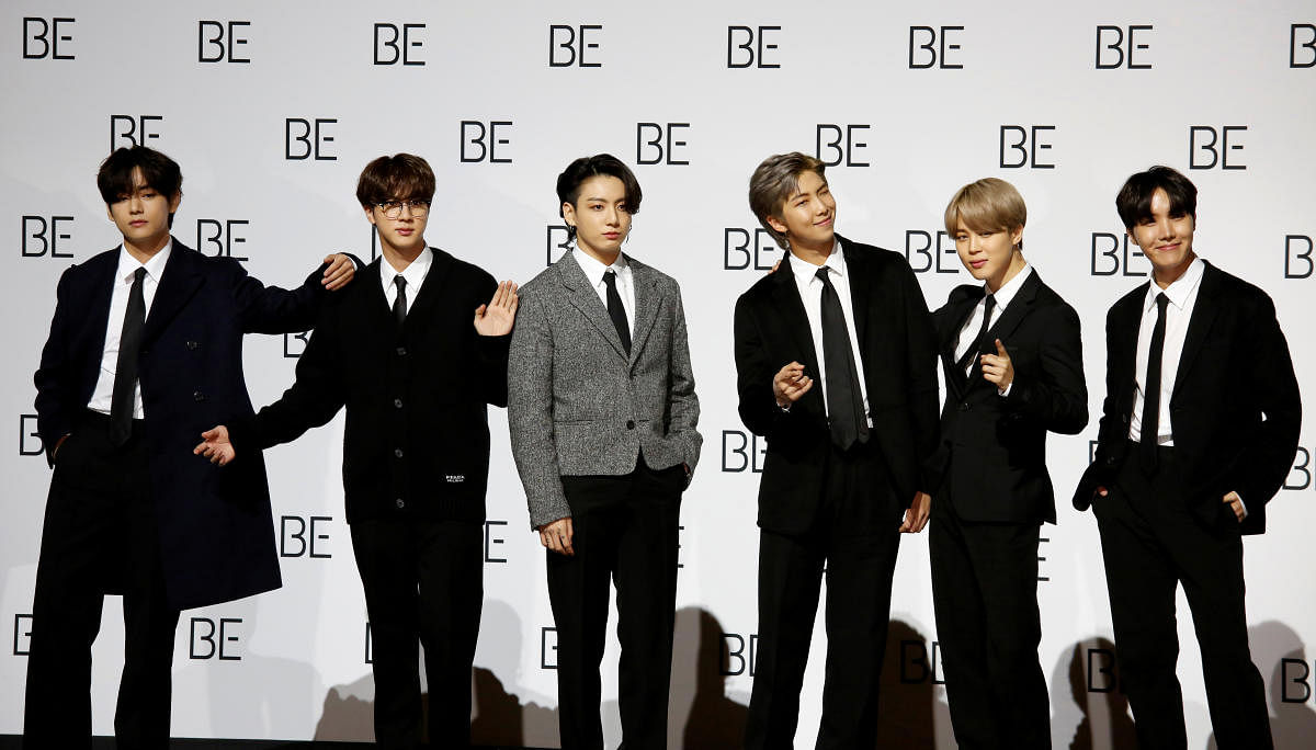 Members of BTS pose for photographs during a promotional event for their new album in Seoul.Reuters