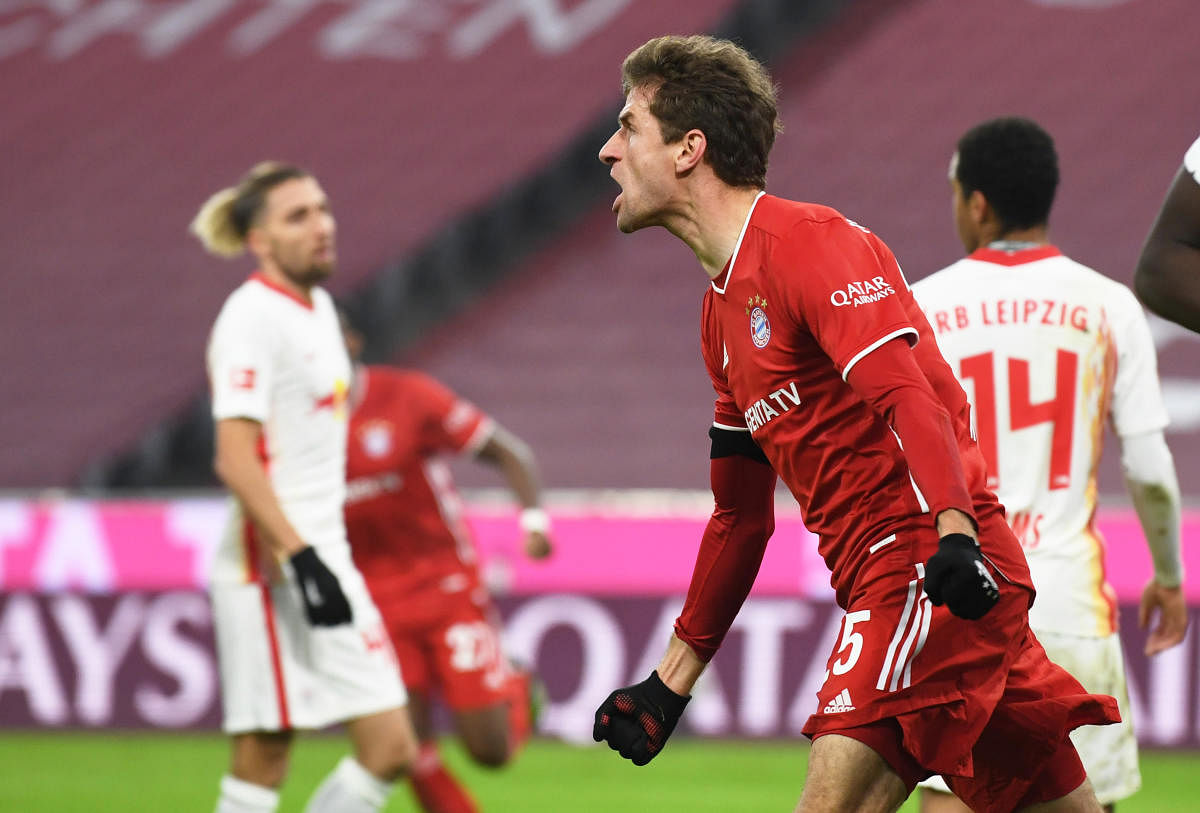 Bayern Munich's German forward Thomas Mueller celebrates scoring the 3-3 goal during the German first division Bundesliga football match FC Bayern Munich v RB Leipzig in Munich. Credit: AFP. 