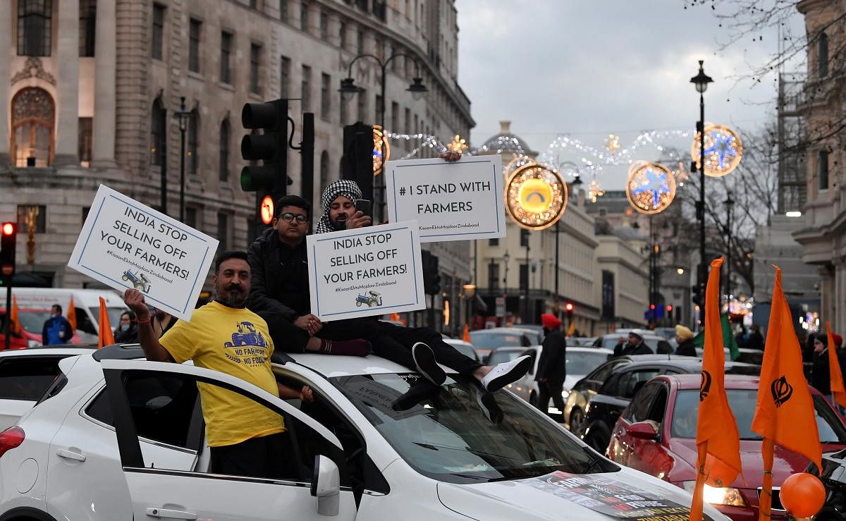 Demonstrators gesture from a vehicle as British Sikhs protest against India's new farming legislation, in London, Britain, December 6, 2020. Credit: REUTERS