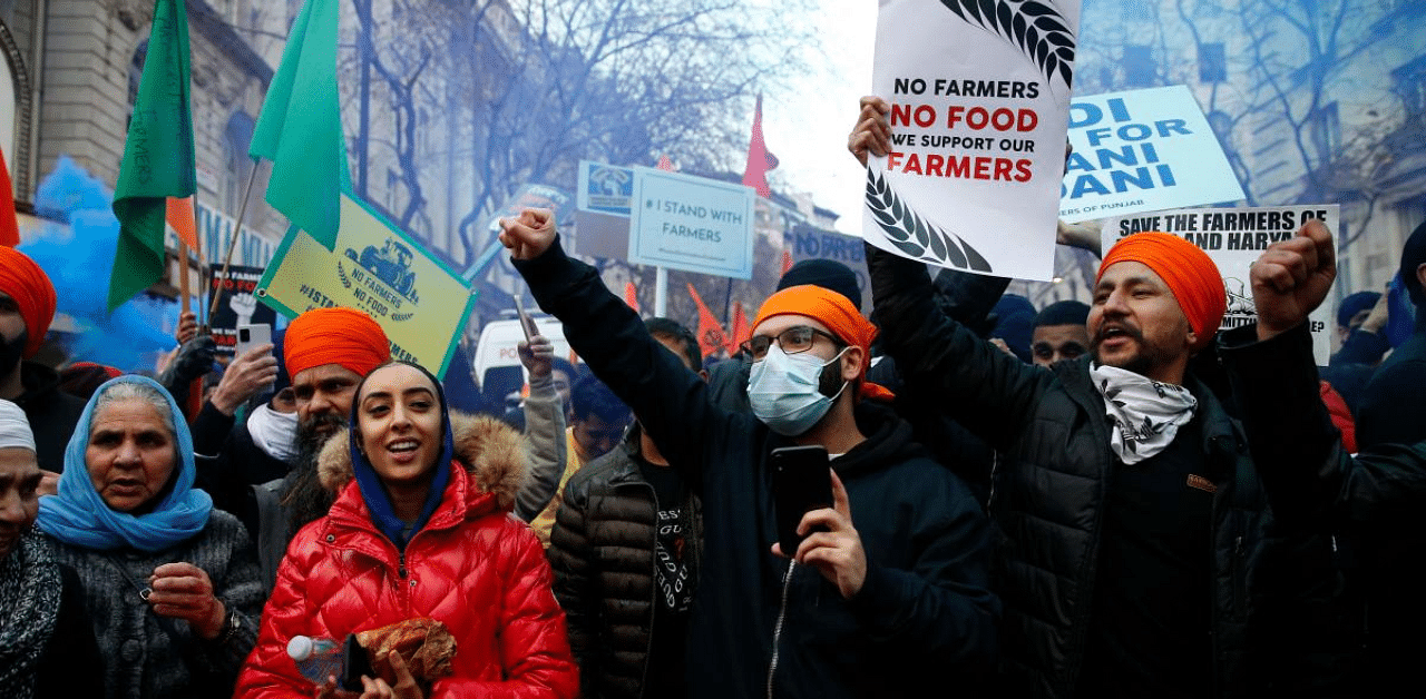 Protesters hold up placards as the gather outside the Indian High Commission in London. Credit: AFP Photo