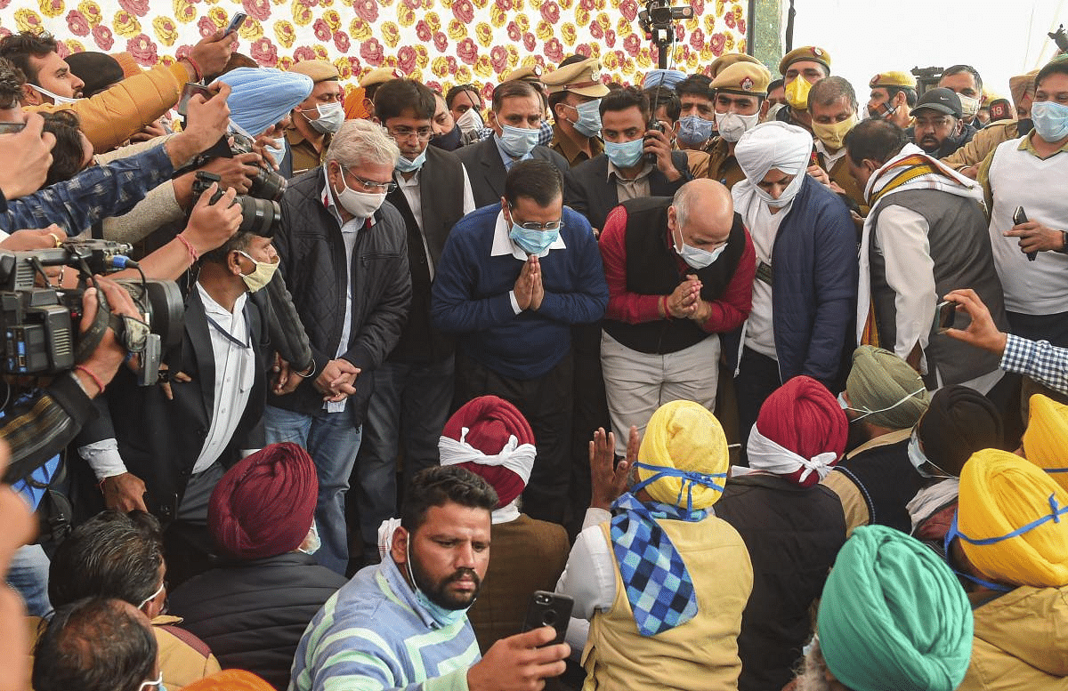 Delhi Chief Minister Arvind Kejriwal and Dy CM Manish Sisodia interact with the farmers while visiting the Guru Tegh Bahadur Memorial Delhi Museum to review the arrangements for the farmers agitating against new farm laws, at Singhu border in New Delhi. Credit: PTI Photo