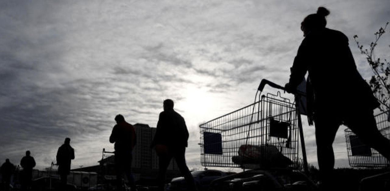 Shoppers queue to enter a Tesco supermarket, as the spread of Covid-19 continues, in West London. Credit: Reuters