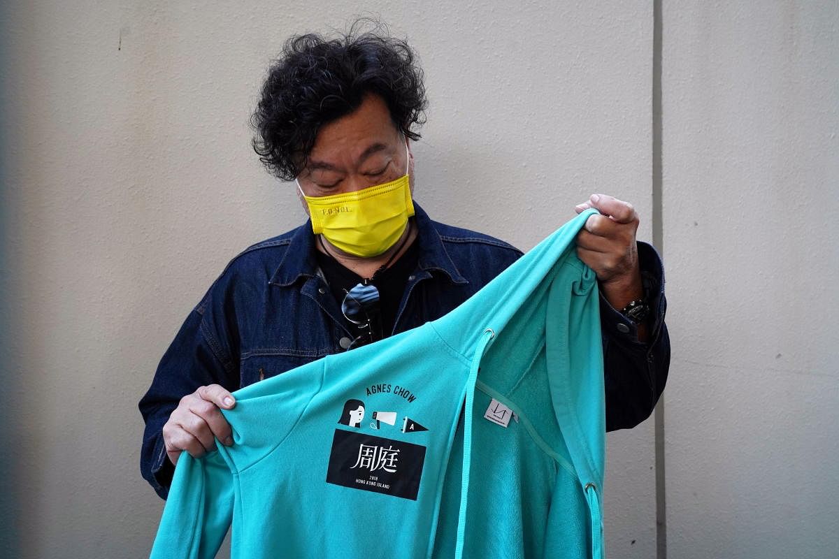 A man holds up a jacket after the sentencing of pro-democracy activists Joshua Wong, Agnes Chow and Ivan Lam, at West Kowloon Magistrates' Courts in Hong Kong, China December 2, 2020. Credit: REUTERS