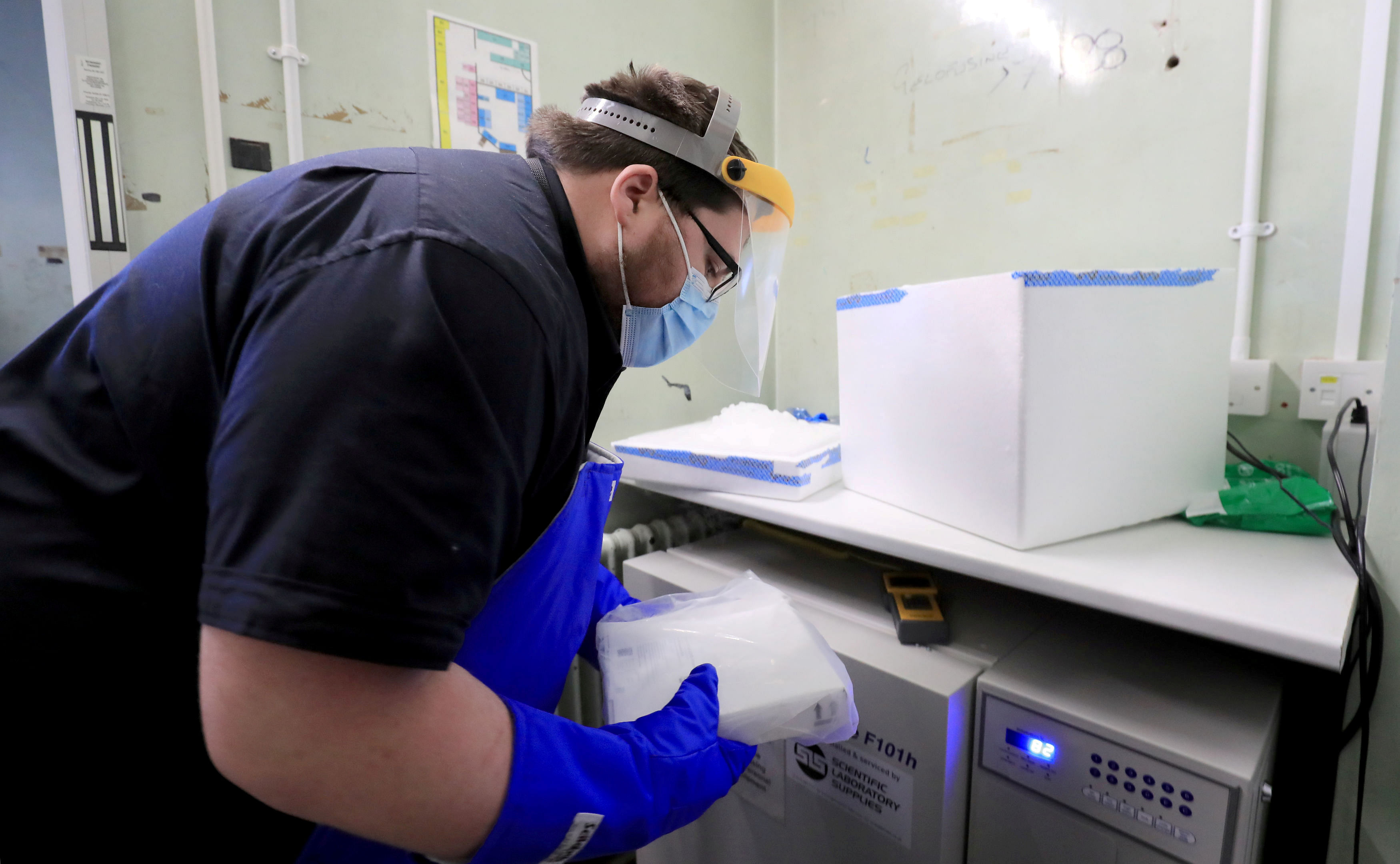 A pharmacy technician from Croydon Health Services prepares a delivery of the first batch of Covid-19 vaccinations at Croydon University Hospital in Croydon. Credit: Reuters Photo