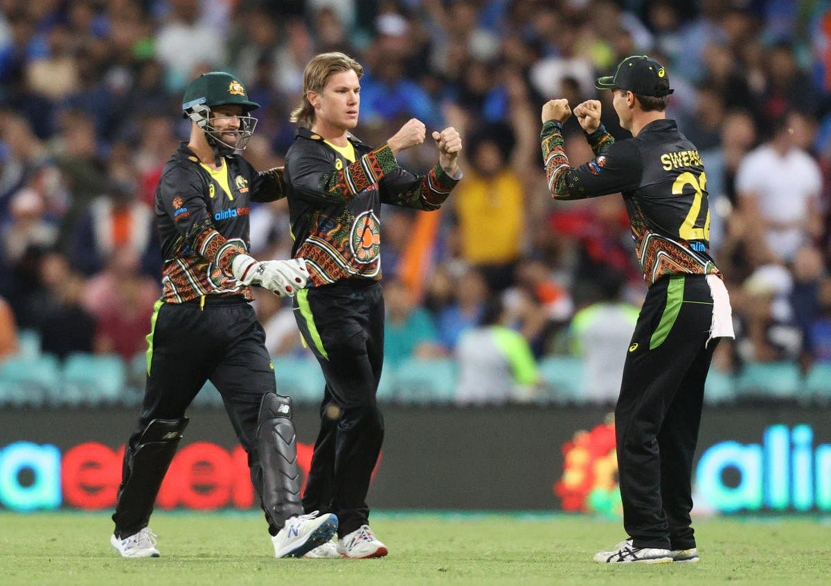 Australia's Adam Zampa celebrates with teammates after taking the wicket of India's Hardik Pandya, caught by Aaron Finch. Credit: REUTERS