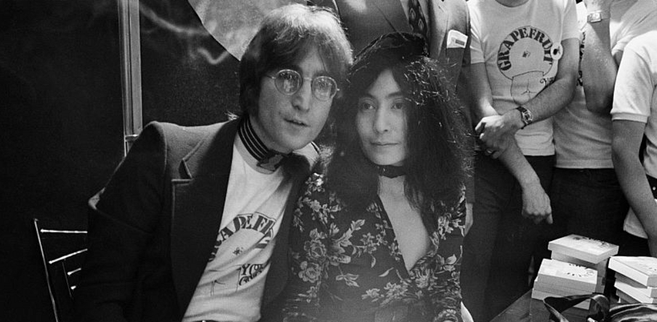 Singer and songwriter John Lennon with his wife Yoko Ono, signing copies of her conceptual art book 'Grapefruit' at Selfridges, London, 15th July 1971. Credit: Getty Images