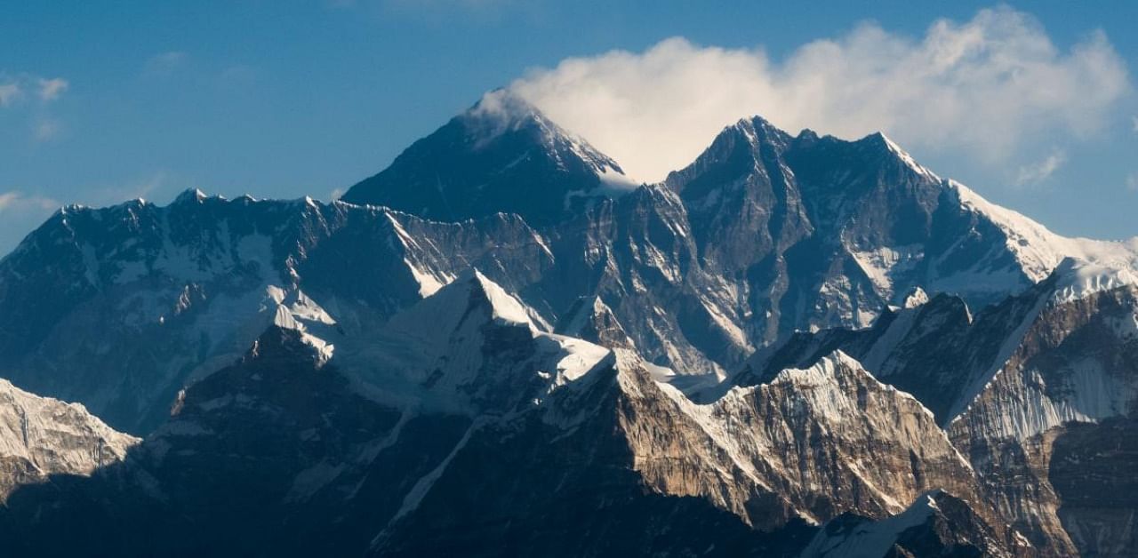 This file photo taken on February 7, 2020 from a commercial aircraft shows an aerial view of Mount Everest (C) and the Himalayan mountain range, some 140kms (87 miles) north-east of Kathmandu. Credit: AFP Photo