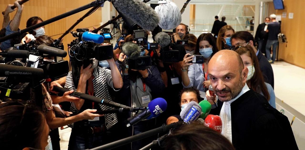 In this file photo taken on September 9, 2020, Charlie Hebdo's lawyer Richard Malka (R) talks to the press at the "Tribunal de Paris" courthouse in Paris, during the trial of 14 people suspected of being accomplices in the Charlie Hebdo and Hyper Cacher jihadist killings. Credit: AFP Photo