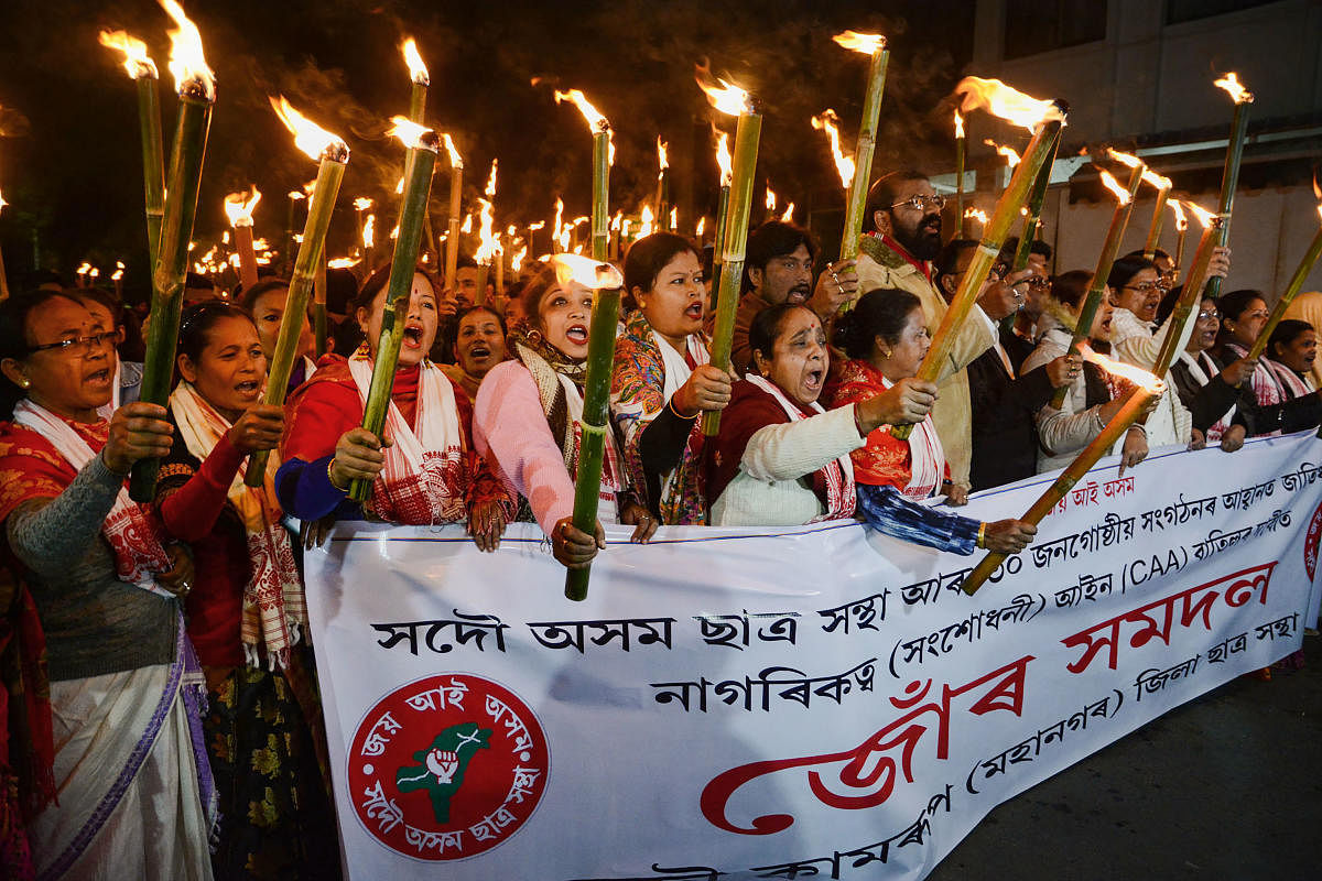 Activists of All Assam Students Union take part in a torch rally against the amended Citizenship Act, in Guwahati. Credit: PTI file photo. 