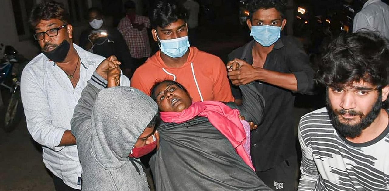 A woman showing symptoms of epilepsy being taken to a hospital in Eluru. Credit: PTI Photo