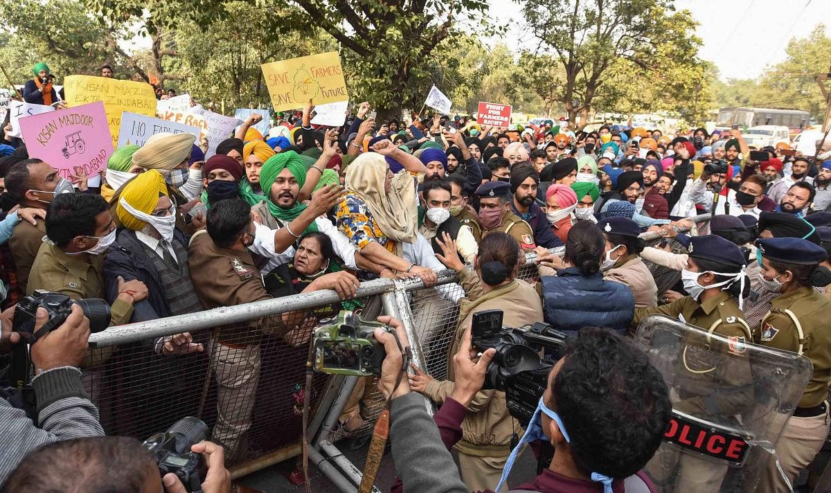 Chandigarh: Police stop farmers during their protest march against the Center's new farm laws, in Chandigarh, Tuesday, Dec. 8, 2020.Various farmer unions today called for a nationwide strike demanding repeal of the agri laws. Credit: PTI Photo