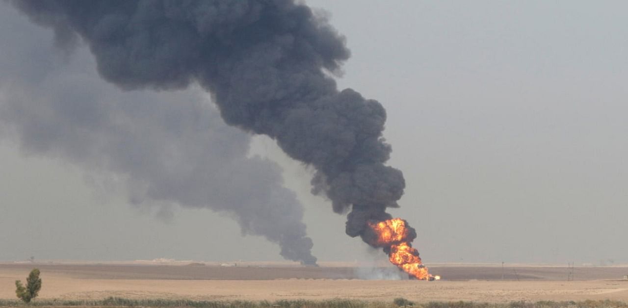 Smoke rises from oil wells inside the Khabbaz oilfield after bombs attack on the outskirts of Kirkuk. Credit: Reuters Photo