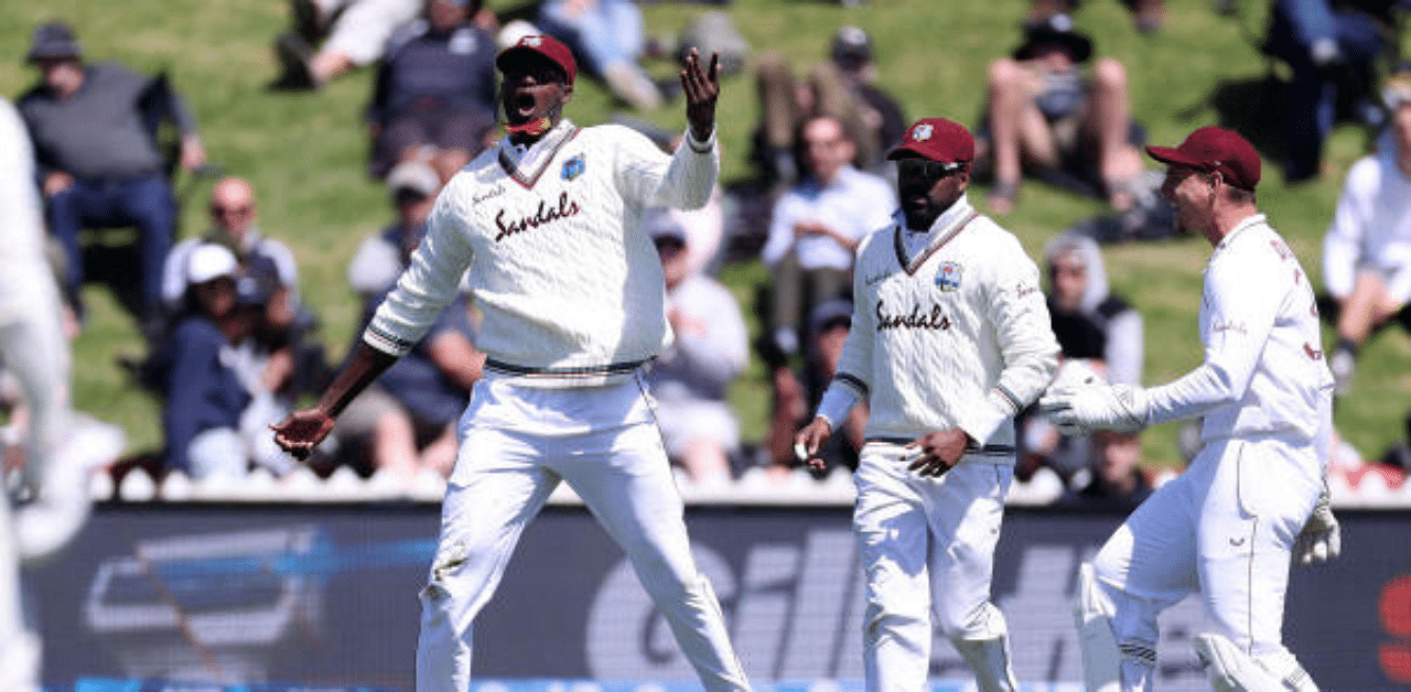 West Indies captain Jason Holder (C) celebrates catching New Zealand's Will Young with teammates during the 2nd International cricket Test match between New Zealand and the West Indies at the Basin Reserve in Wellington. Credit: AFP