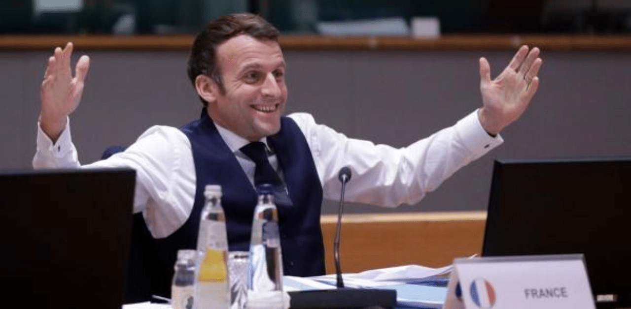 France's President Emmanuel Macron gestures after a night of negotiation during a round table meeting in the EU summit at the European Council building in Brussels. Credit: AFP