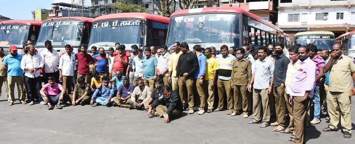 KSRTC workers hold a protest in Madikeri bus stand on Friday.