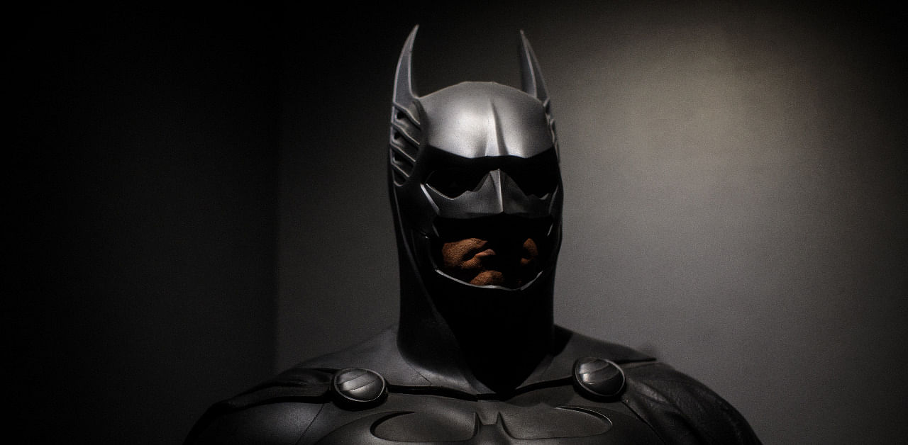 A Batman costume from the 1995 Batman Forever film worn by Val Kilmer and designed by Rob Ringwood and Ingrid Ferrin is on display at the DC Comics Exhibition. Credit: Getty Images