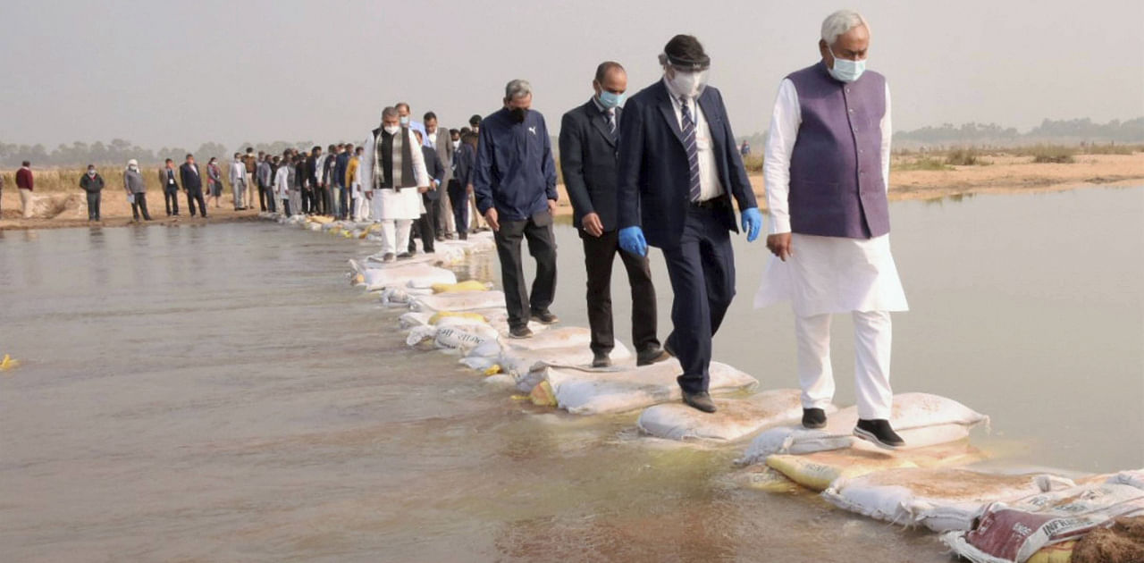 Bihar Chief Minister Nitish Kumar crosses River Chandan during his visit to an archaeological site in Banka district, Saturday, Dec. 12, 2020. Credit: PTI Photo