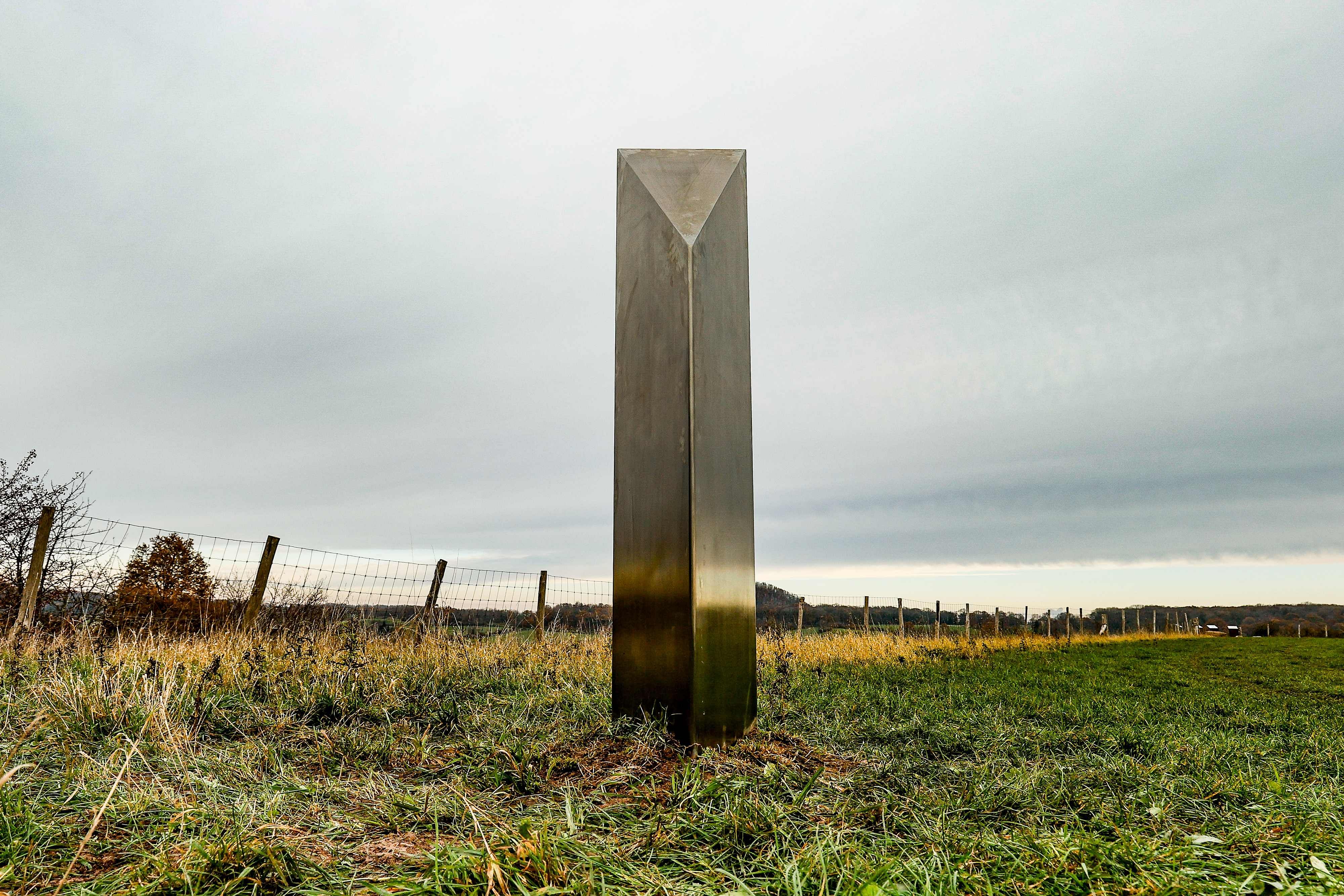   A picture taken on December 10, 2020 shows a mysterious metal monolith, similar to others appearing in Europe and USA, which was discovered in the nature reserve area Tiendeberg, in Riemst. - Several mysterious metal monoliths has appeared on a heath in the Netherlands, the United States, Romania and Britain since the first one in Utah last month. An anonymous art collective has taken credit for the Utah installation but no one has claimed responsibility for those in Romania, the Isle of Wight and the Netherlands. Credit: AFP
