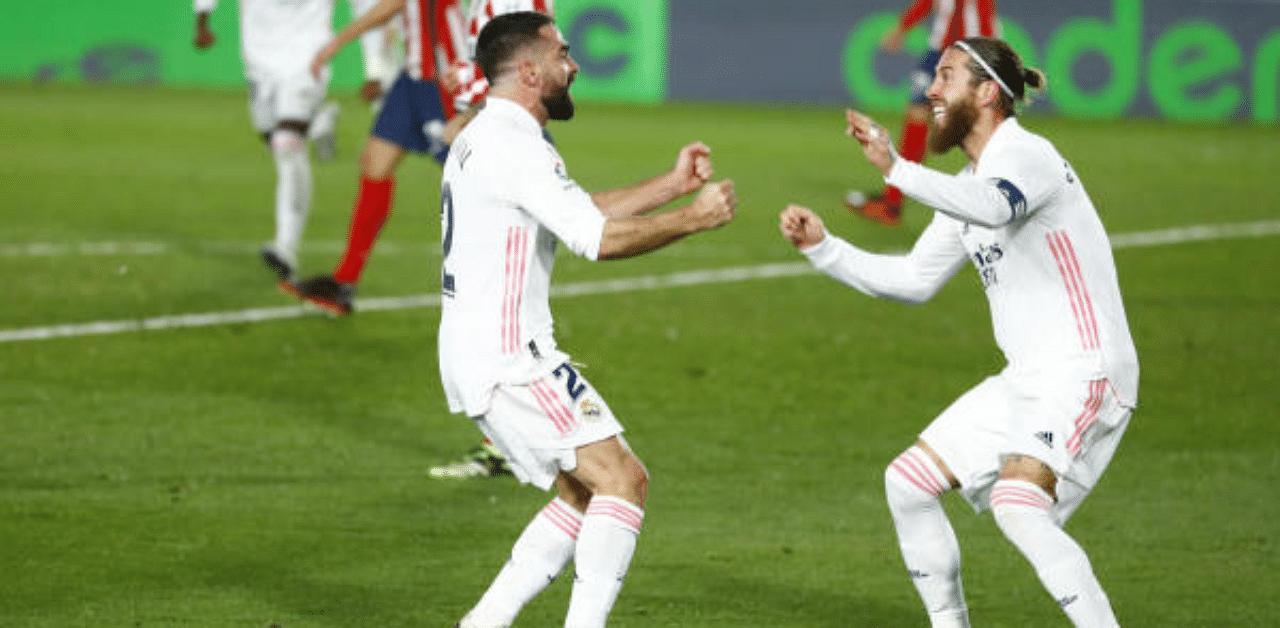 Real Madrid's Dani Carvajal celebrates with Sergio Ramos after Atletico Madrid's Jan Oblak scored an own goal. Credit: Reuters