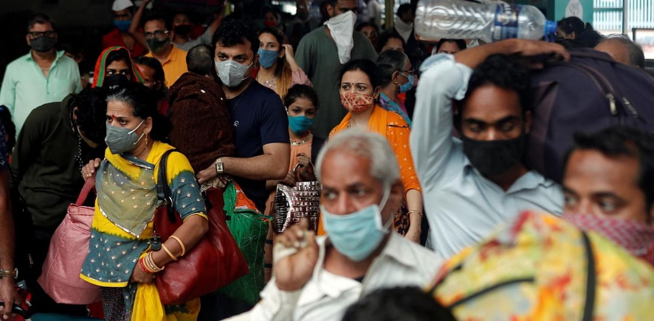People wearing protective masks exit a railway station amid the spread of the coronavirus disease in Mumbai. Credit: Reuters Photo