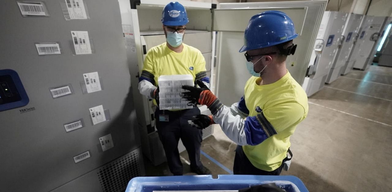 People prepare boxes containing the Pfizer-BioNTech Covid-19 vaccine at the Pfizer Global Supply Kalamazoo manufacturing plant in Portage. Credit: Reuters photo.