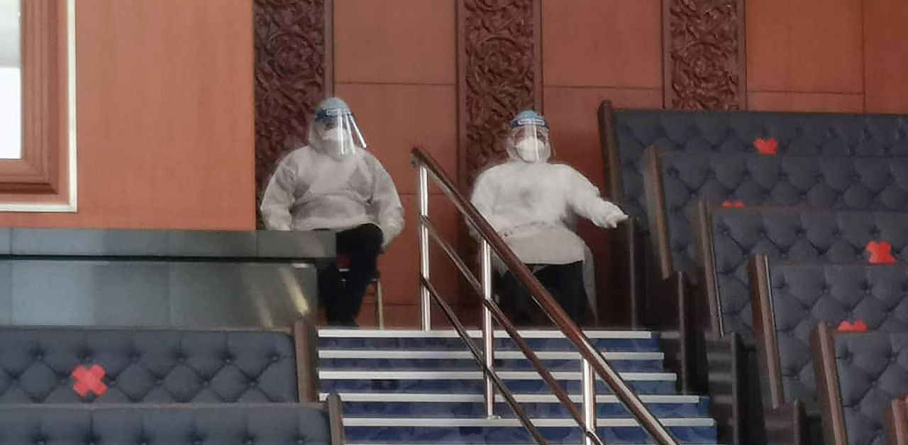 Ruling party politicians, who had been required to be in quarantine due to contact with someone with a case of the Covid-19 coronavirus, wearing full personal protective equipment. Credit: AFP Photo