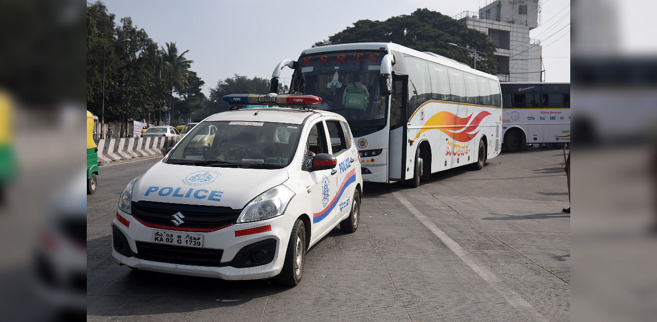 Police escort KSRTC buses with police protection during the strike by employees. Credit: DH Photo/ Representative