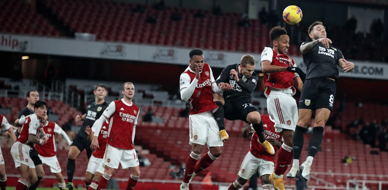 Arsenal's Gabonese striker Pierre-Emerick Aubameyang (2nd from Right) heads the ball toward the goal and into his own net to score an own goal during the Premier League football match between Arsenal and Burnley at the Emirates Stadium in London. Credit: AFP
