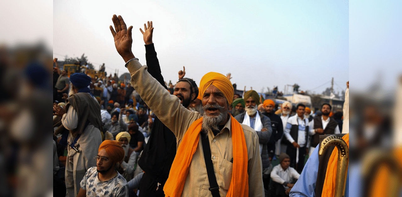 In this picture taken on December 5, 2020 Sandeep Singh (C), 65, a farmer from Rauni village in Ludhiana district of the northern Indian state of Punjab, shouts slogans during a rally along a road blocked by police to stop farmers from marching to New Delhi to protest against the central government's recent agricultural reforms, at the Delhi-Haryana state border in Kundli. Credit: AFP Photo