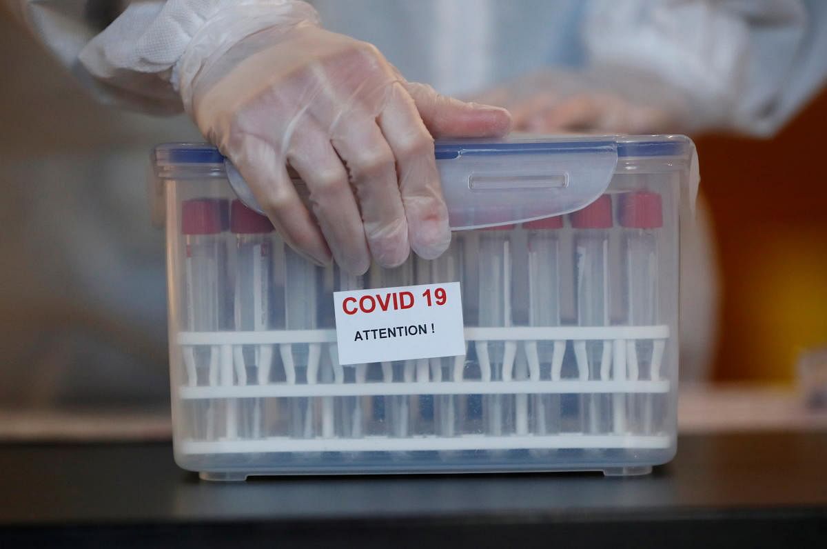 A medical worker holds test tubes for nasal swab at a coronavirus disease (COVID-19) testing centre in Nantes, France, December 10, 2020. Credit: REUTERS