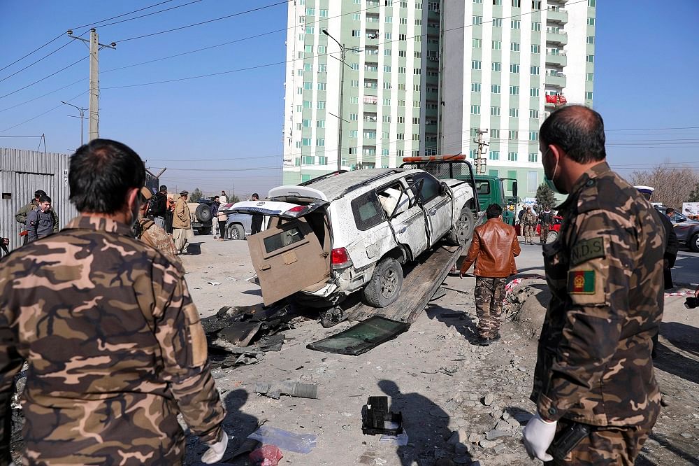 Afghan security personnel inspect the site of a bomb attack in Kabul. Credit: AP Photo