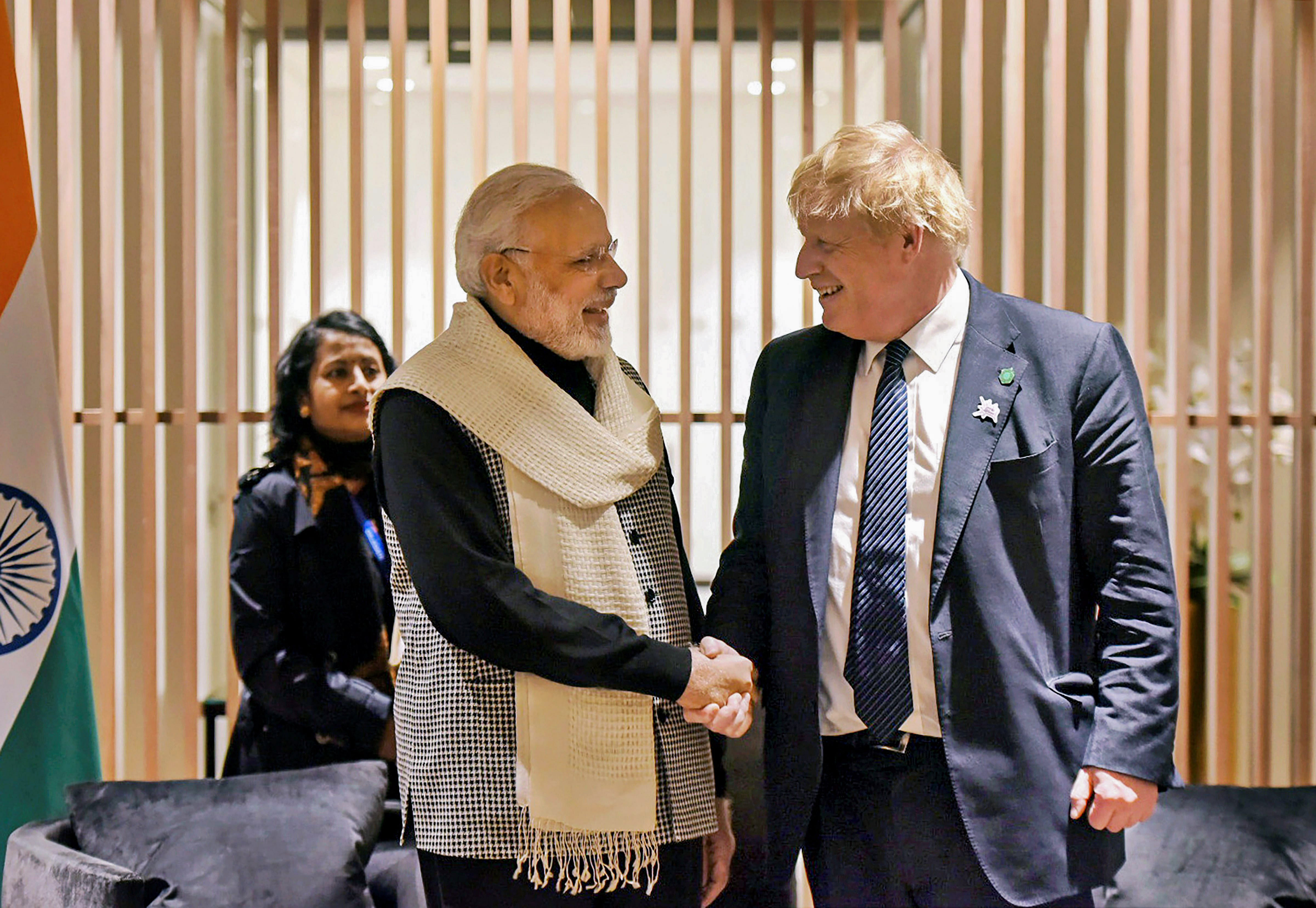Prime Minister Narendra Modi shakes hands with then Britain Prime Minister Boris Johnson. Credit: AFP Photo