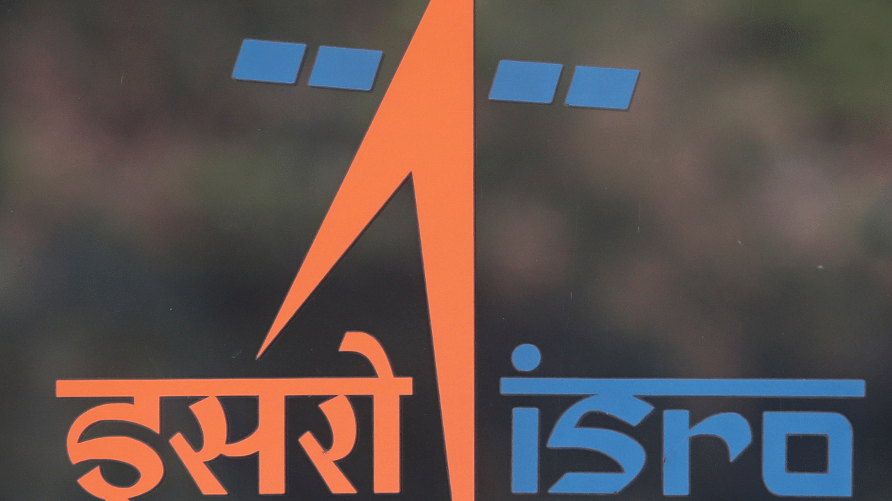 A security guard stands behind the logo of Indian Space Research Organisation (ISRO) at its headquarters in Bengaluru. Credit: Reuters Photo