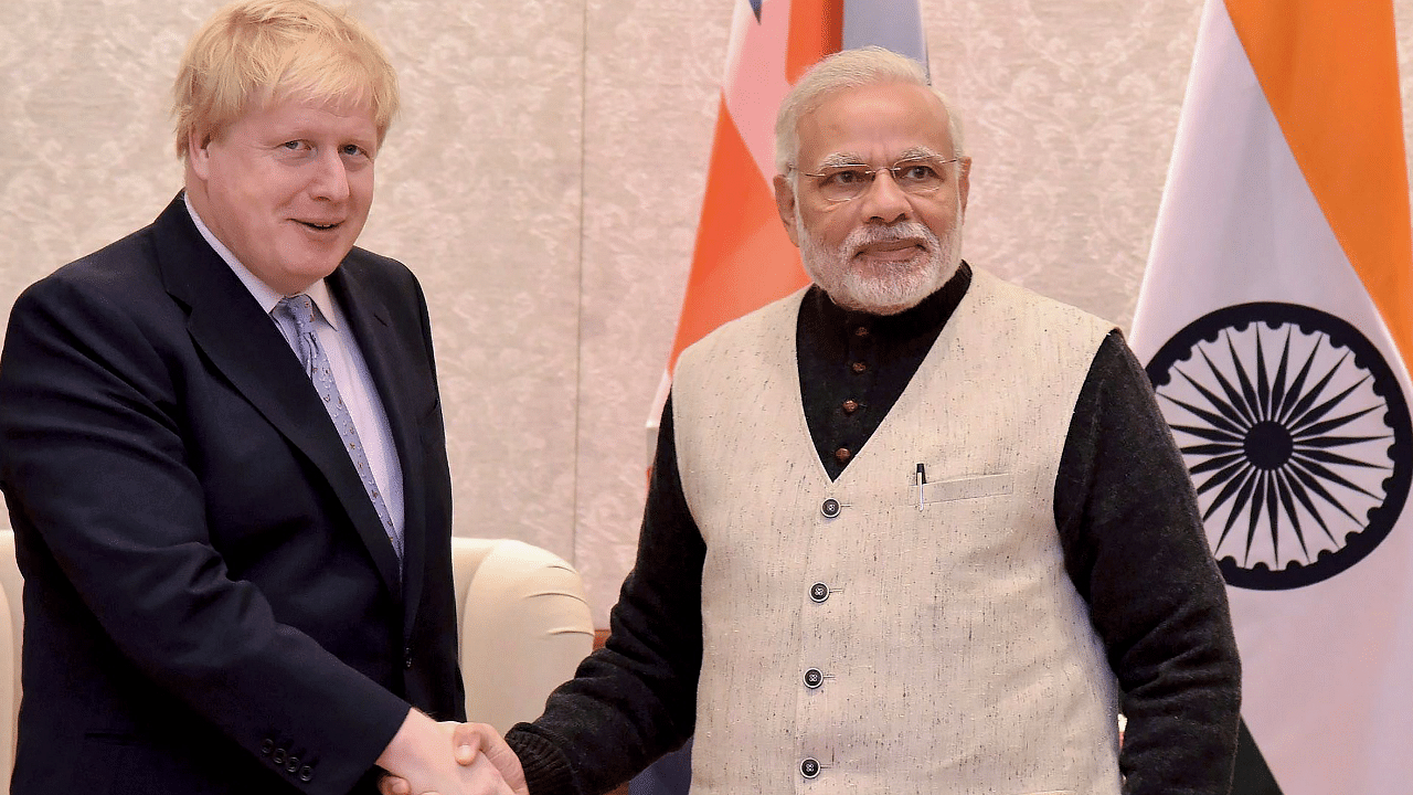 Prime Minister Narendra Modi shakes hands with British Prime Minister Boris Johnson. Credit: AFP Photo
