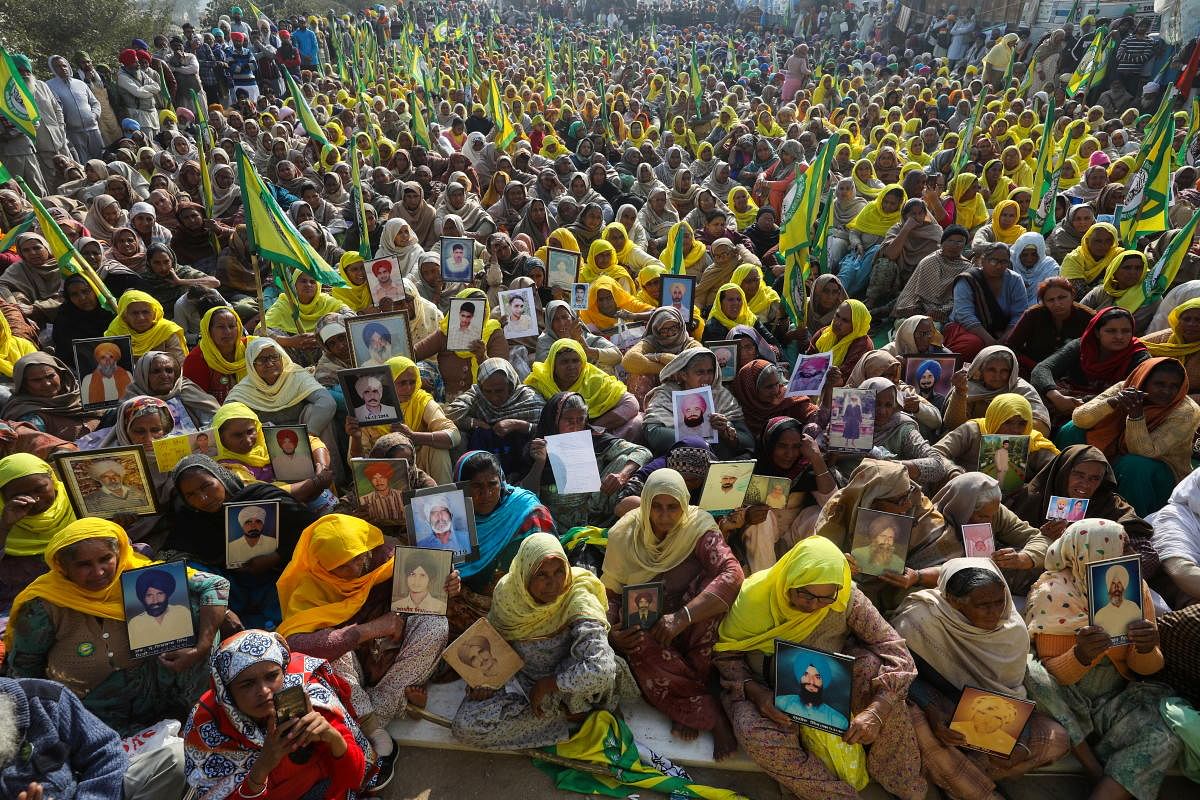Women, including widows and relatives of farmers who were believed to have killed themselves over debt attend a protest against farm bills. Credit: Reuters