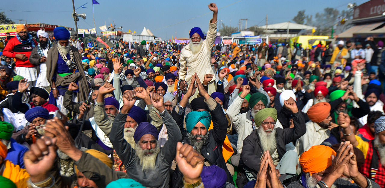 Farmers shout slogans during their protest against the new farm laws, at Singhu Border in New Delhi. Credit: PTI Photo