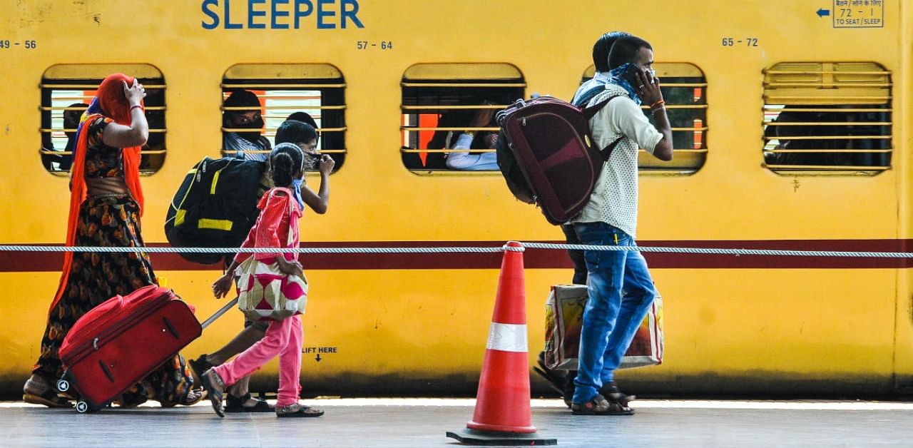 Migrants from Lucknow wait to board 'Shramik Special' train to reach their native places at Panvel Railway Station, during the ongoing Covid-19 lockdown, in Navi Mumbai. Credit: DH Photo
