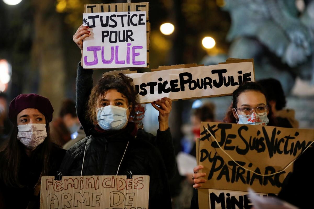 Women attend a gathering to protest femicides and violence against women in Paris to mark the International Day for the Elimination of Violence Against Women, France, November 25, 2020. The placard reads: "Justice for Julie". Credit: REUTERS