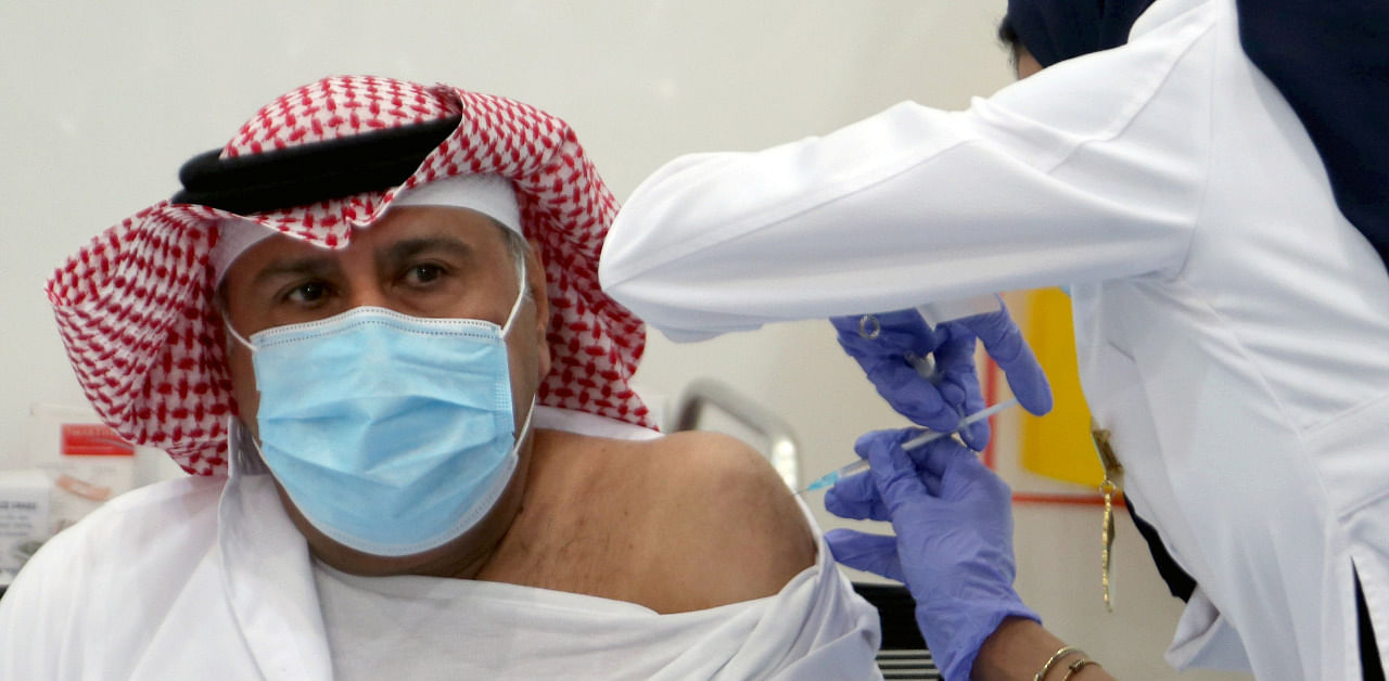 A Saudi man gets a dose of a coronavirus disease (COVID-19) vaccine, in Riyadh, Saudi Arabia. Credit: Reuters Photo